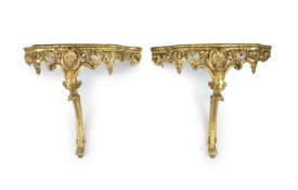 A pair of Louis XV style carved giltwood console tablesWith serpentine white marble tops, scroll
