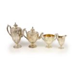 A Victorian embossed silver four-piece tea and coffee service of classical vase form, London 1886,