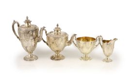 A Victorian embossed silver four-piece tea and coffee service of classical vase form, London 1886,