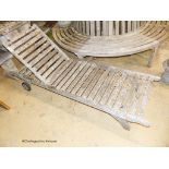 A pair of weathered teak garden loungers, length 198cm