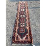 A Caucasian design green ground runner, 340 x 76cm