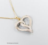 A modern 375 and diamond chip set openwork heart pendant, 22m, on a 9ct gold fine link chain, 46cm,