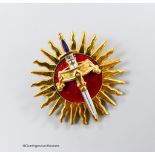 A modern 9ct gold and red enamel brooch, modelled as a sword and crown, with sun background,