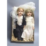 A pair of Armand Marseille 390 bisque head groom and bride dolls, tallest 50cm