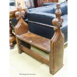 A pair of 15th century oak pew ends with stylised leaf and berry fleur-de-lys finials, joined by a