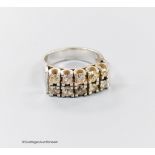 A modern 18ct white metal and ten stone diamond set two row half hoop ring, size O/P, gross weight