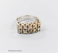 A modern 18ct white metal and ten stone diamond set two row half hoop ring, size O/P, gross weight