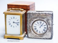 A cased carriage clock and a silver mounted motorwatch