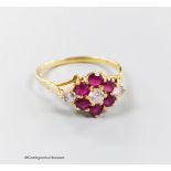 A modern 18ct gold, ruby and diamond set cluster ring, size T, gross 3.8 grams.