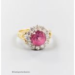 A modern yellow metal, pink tourmaline and diamond set circular cluster ring, size O, gross 5.1