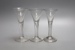 Three Georgian drawn trumpet ale glasses, tallest 17cmwith air trap stems