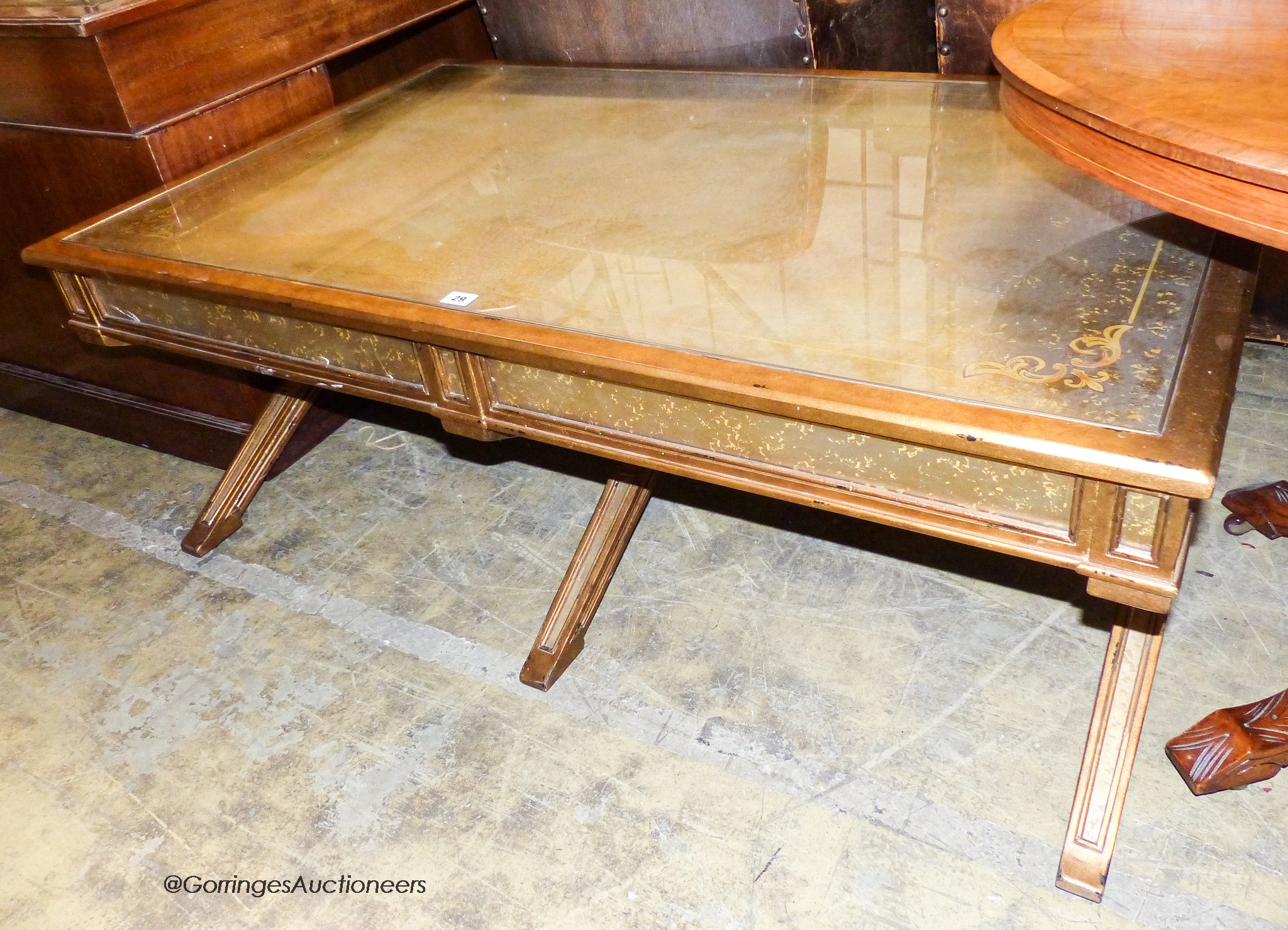 An Italian style gilt and glass 'X' frame coffee table fitted end drawers, length 132cm, depth