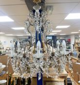 A gilt metal cut glass and lustre hung seven light chandelier84cm high