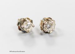 A modern pair of 750 white metal and solitaire diamond ear studs, each stone weighing approximately