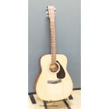 A Yamaha F310 acoustic guitar, carry case