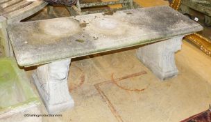 A reconstituted stone bench, with moulded rectangular top on stylised lion end supports, width