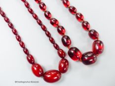 Two single strand graduated simulated cherry amber oval bead necklaces, longest 98cm, gross weight