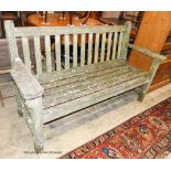 A weathered teak garden bench, length 160cm, depth 56cm, height 90cm