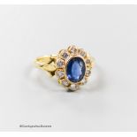 A modern 18ct gold, sapphire and diamond set oval cluster ring, size N, gross 3.8 grams.