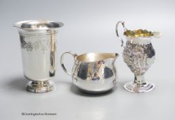 A George III later embossed silver cream jug with later base?, 11.5cm, a modern silver cream jug