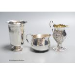 A George III later embossed silver cream jug with later base?, 11.5cm, a modern silver cream jug