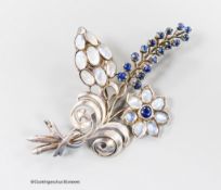 A white metal, moonstone and cabochon blue quartz? cluster set floral spray brooch, 91mm, gross