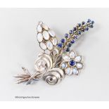 A white metal, moonstone and cabochon blue quartz? cluster set floral spray brooch, 91mm, gross
