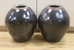 A pair of large monochrome brown glazed jars, height 40cm