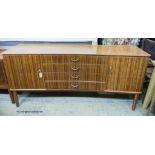 A Gordon Russell Ltd teak and Indian Laurel concave sideboard Model R810 circa 1960, length 183cm,