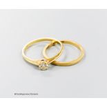 An 18kt and solitaire diamond ring and an 18ct gold wedding band, gross 2.5 grams.