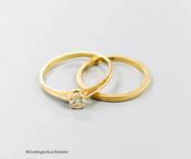 An 18kt and solitaire diamond ring and an 18ct gold wedding band, gross 2.5 grams.