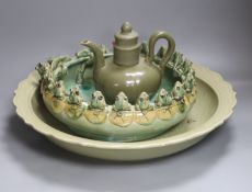 A large Chinese celadon glazed dish, a Chinese green crackle glaze ewer and cover and a 'frog pond'