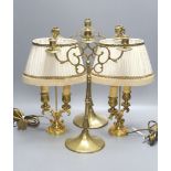 A pair of 19th century brass three branch candlesticks and a pair of twin branch table lamps,