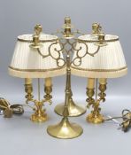 A pair of 19th century brass three branch candlesticks and a pair of twin branch table lamps,
