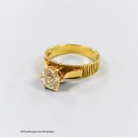 A textured 18ct and solitaire diamond ring, size Q, gross weight 5.4 grams, the stone diameter 7.