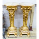 A pair of onyx top gilt pedestals, height 98cm