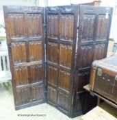 An oak three-fold screen incorporating twenty-four 16th / 17th century linenfold-carved panels,