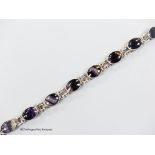 A white metal and nine stone cabochon blue john set bracelet, overall 19cm.