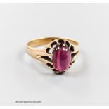 An Edwardian 9ct gold and cabochon garnet set dress ring, size U, gross 4.6 grams.