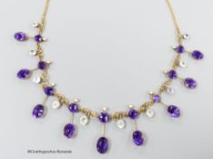An early 20th century yellow metal, amethyst, aquamarine and seed pearl set drop fringe necklace,