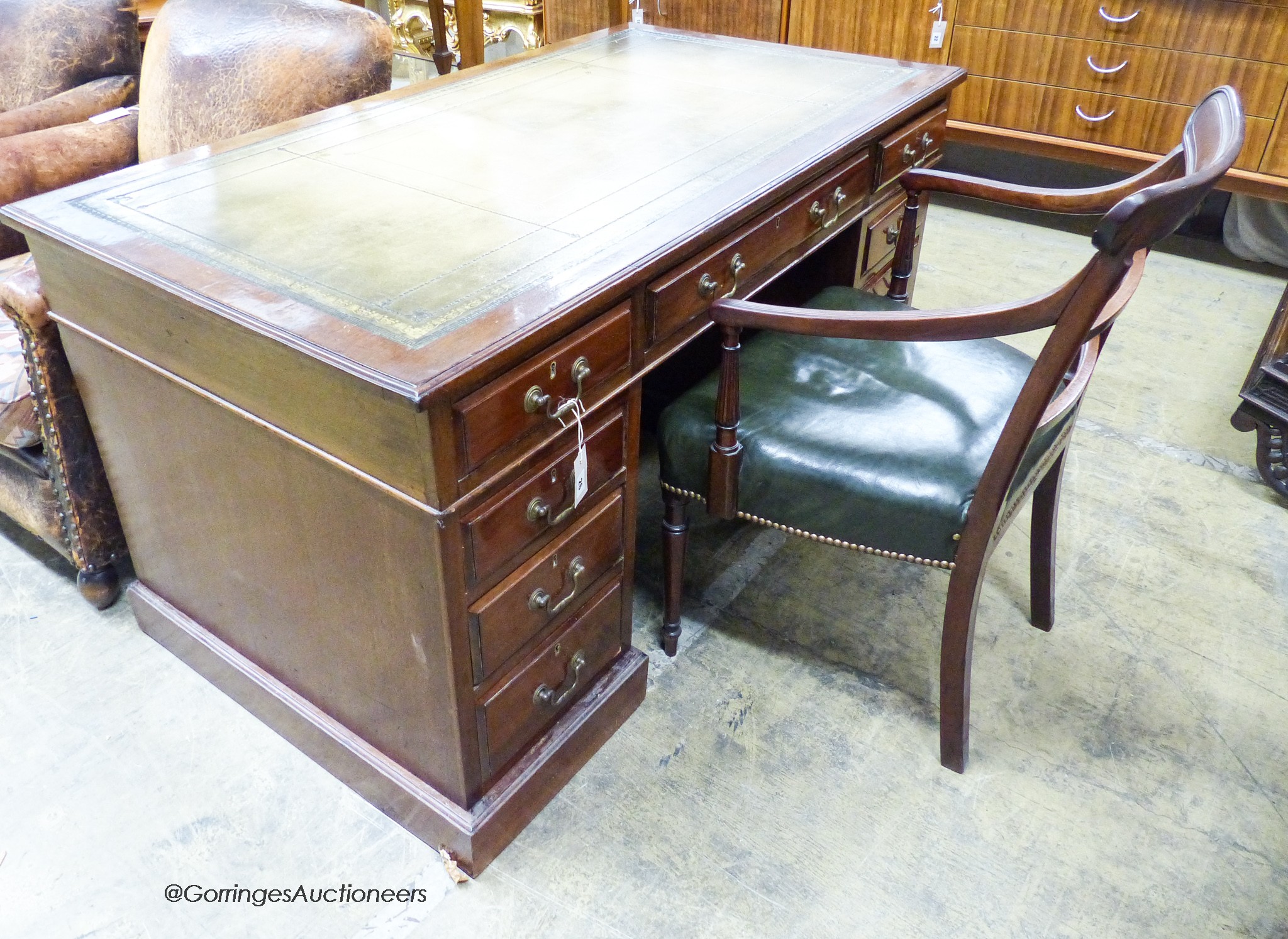 An Edwardian mahogany pedestal desk, length 138cm, depth 75cm, height 74cm together with a George