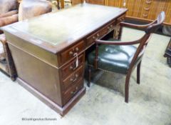 An Edwardian mahogany pedestal desk, length 138cm, depth 75cm, height 74cm together with a George