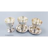 A pair of 1950's silver egg cups, Walker & Hall, Sheffield, 1957/8, 55mm and one other silver egg