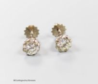 A modern pair of 18ct and solitaire diamond set ear studs, each stone weiging approximately 0.65ct-