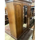 A Victorian mahogany triple mirrored wardrobe, bears Heals & Son brass plaque, width 190cm, depth