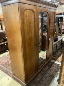 A Victorian mahogany triple mirrored wardrobe, bears Heals & Son brass plaque, width 190cm, depth