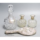 A pair of George V silver mounted scent bottles, (a.f.) 11.6cm, a repousse silver mounted hand