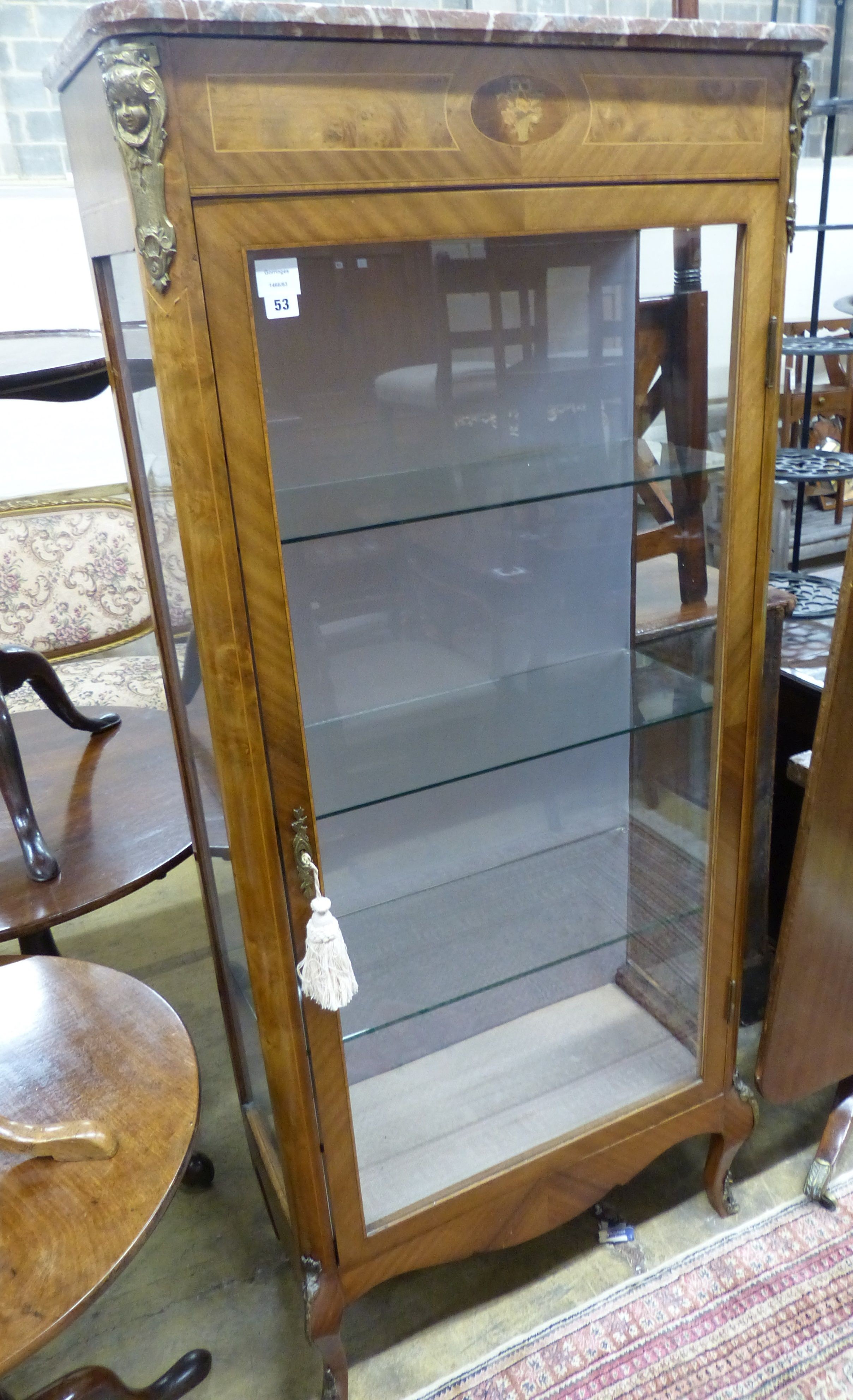 A late 19th century Louis XV style vitrine, with a shaped marble top above a single glazed panelled