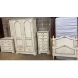A French provincial style bedroom suite, cream painted, with blue line edging, consisting:- a two