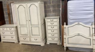 A French provincial style bedroom suite, cream painted, with blue line edging, consisting:- a two